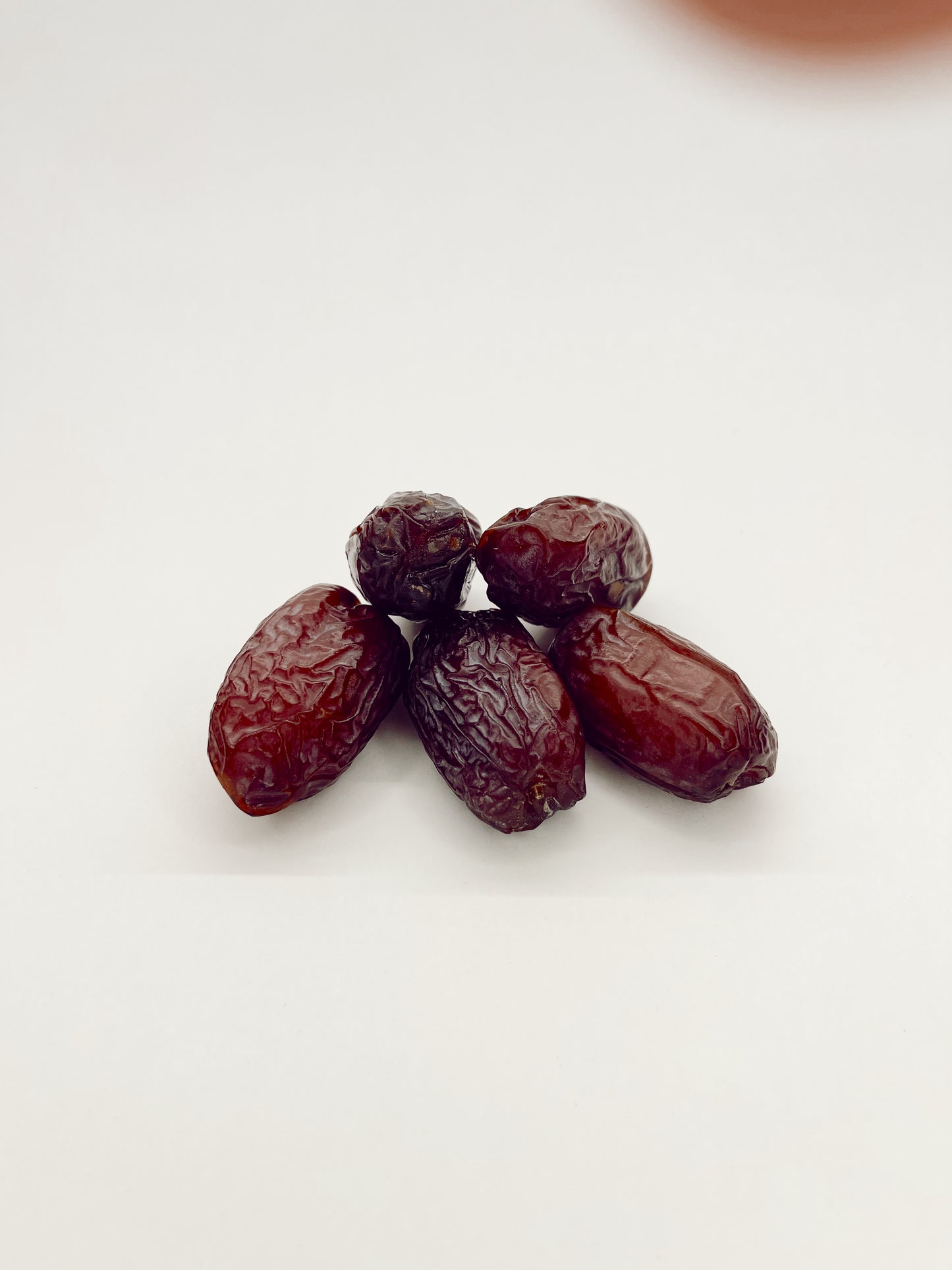 Frontal display of Jumbo Organic Medjool Dates highlighting their rich color and organic quality.